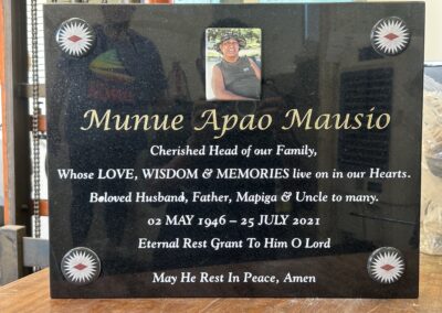 An image of a plaque headstone with intricate engravings, offering a personalized memorial tribute